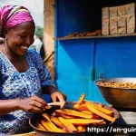 Home 22 기니에서 전통적으로 소비되는 스낵 - **Vibrant Guinean Street Food Market Scene:**
A bustling and colorful open-air market in Guinea ...